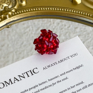 Macro detail of red crystal beaded flower charms for shoes with vintage romantic styling