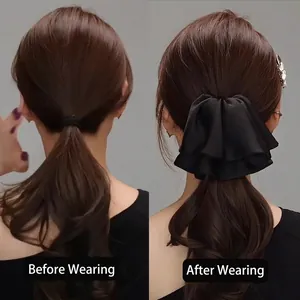 Elegant black satin double-layer bow hair clip showing voluminous hairstyle effect