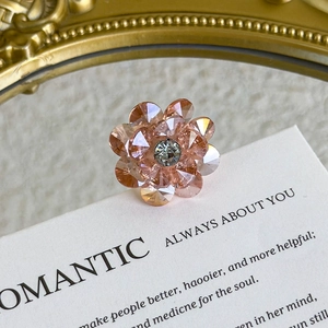 Macro view of peach crystal flower shoe charms with delicate facets for DIY decoration