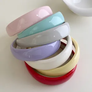 Minimalist glossy candy-colored headband collection in multiple vibrant patent leather shades