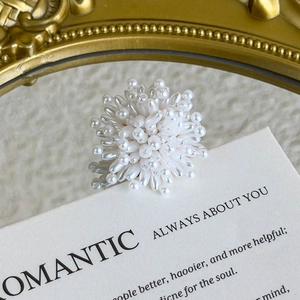 Macro detail of white cluster bead ring with miniature pearls in elegant flower shape