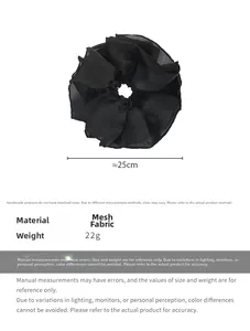 Detail view of large black mesh scrunchie showing 25cm diameter and soft pleated texture