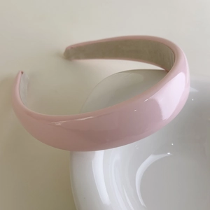 Close-up of pink glossy patent leather sponge headband with non-slip fabric lining