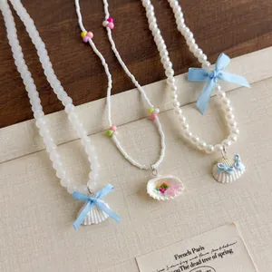 Collier de Künstliche Perles Fait Main Avec Coquillage Résine Verre Künstliche Perle Nœud Bleu Chaîne de Clavicule Bijoux de Style Vacances Femme