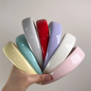 Detail of colorful shiny patent leather padded headbands in various dopamine colors