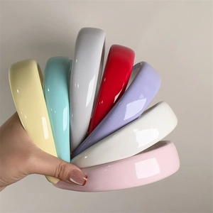 Set of seven glossy candy-colored sponge headbands held in a fan shape showing textures