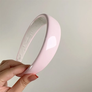 Detail view of pink patent leather headband with white velvet non-slip inner lining