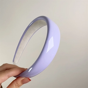 Macro shot of light purple shiny patent leather padded headband with anti-slip lining