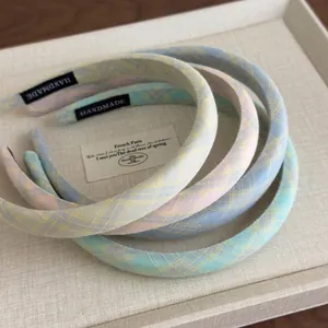 Set of four pastel plaid headbands in macaron colors featuring handmade woven labels