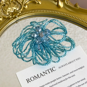 Detail of light blue beaded flower shoe charm with sparkling crystals and rhinestones