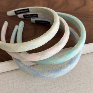 Pastel plaid narrow headbands set with handmade tag on rustic wood background