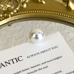 Close-up of high-quality large round white pearl accessory with smooth glossy finish