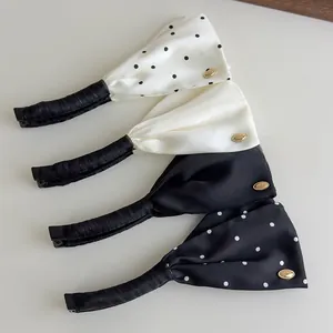 Detailed set of satin polka dot and solid banana hair clips with elegant gold metal buckles