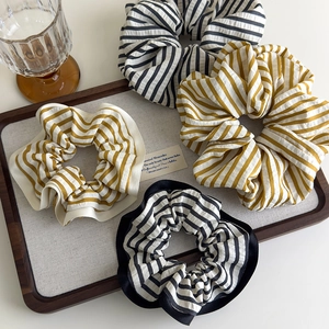 Set of four striped fabric scrunchies in black and yellow for stylish hair styling