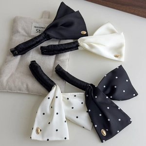 Detailed set of four satin bow banana hair clips in black, white, and polka dot patterns