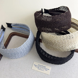 Bohemian wide woven headband set in blue, coffee, beige, and black colors on a tray