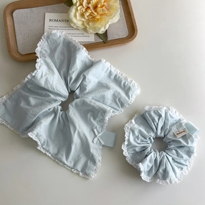 Light blue lace scrunchie set with handmade label and bow for sweet hair styling