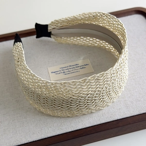 Detail view of Bohemian wide braided headband in cream featuring intricate mesh weaving