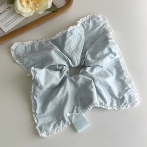 Close-up of light blue scrunchie with white lace trim and silk ribbon bow detail