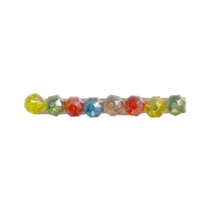 Macro shot of colorful faceted crystal beads on a metal duckbill hair clip