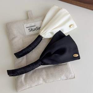 Polka dot satin wing hair clips in black and cream white with elegant golden buckles