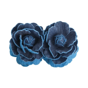 Detailed macro view of vintage denim camellia flower hair clip with frayed petal textures