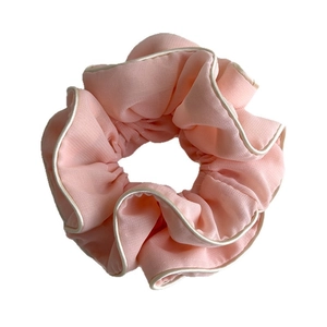 Elegant pale pink chiffon scrunchie with cream pleated edges for sophisticated hairstyles