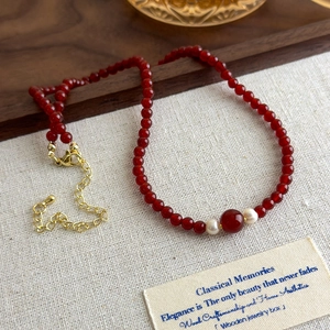 Vintage red agate beaded necklace with elegant pearl accents and a golden lobster clasp