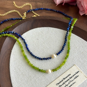 Elegant freshwater pearl necklace with lapis blue beads and gold chain closure