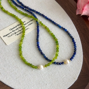 Lapis lazuli and green bead necklace set with freshwater pearls and gold accents