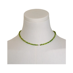 Elegant green beaded necklace featuring a central freshwater pearl on a neck display