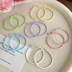 Set of six colorful macaron matte metal hoop earrings in a minimalist round tray