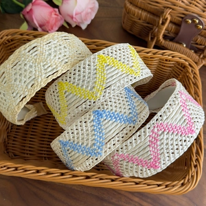 Bohemian woven wide headbands in various colors on a vintage tray with flowers