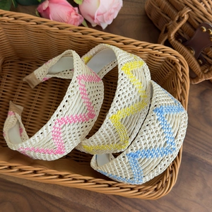 Detail of bohemian woven headbands set in pink, yellow and blue with geometric patterns