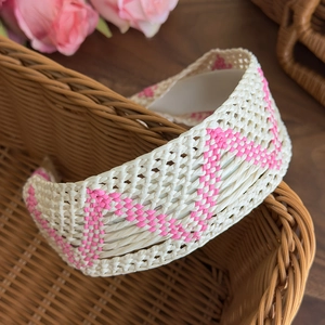 Detail of cream and pink woven bohemian headband with geometric texture and inner lining