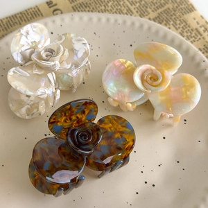 French vintage acetate camellia hair claw clips in marble and tortoise shell patterns