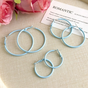 Three pairs of light blue matte hoop earrings in small, medium, and large sizes