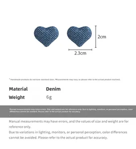 Detail view of denim heart earrings showing navy fabric texture and 2.3cm size dimensions