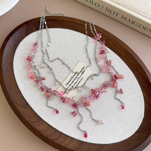Detail of pink flower beads on silver multi-layer choker necklace in vintage setting