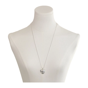 Minimalist silver heart pendant necklace with hammered texture shown on white model