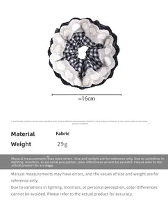 Detail showing navy plaid scrunchie with white lace heart embroidery, 16cm diameter