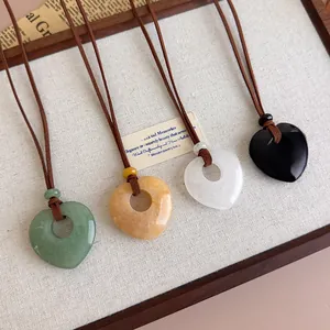 Macro detail of heart-shaped natural stone pendants in four colors on display