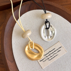 Minimalist irregular geometric pendant necklaces in gold and silver on adjustable cords