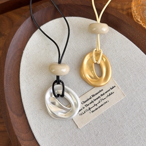 Minimalist geometric pendant necklaces with organic metal rings and adjustable cord