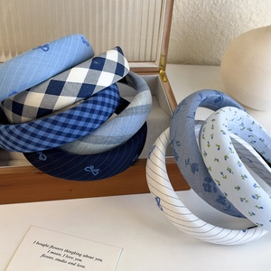 Blue plaid sponge headband set with bow for women showing preppy style and high top hair look