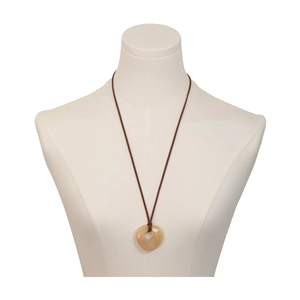 Natural heart-shaped stone pendant necklace with brown cord on a white mannequin