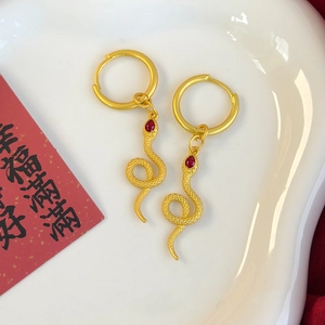 Golden snake zodiac earrings with red gemstone drop pendants in Chinese New Year style