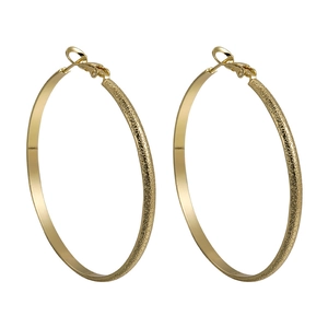 Golden hoop earrings with polished and frosted metal texture surfaces in minimalist style