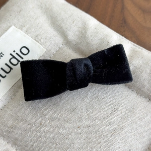 Close-up of black velvet bow hair clip showing fine texture and exquisite craftsmanship