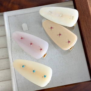 Set of four vintage French iridescent acetate hair clips with inlaid rhinestones